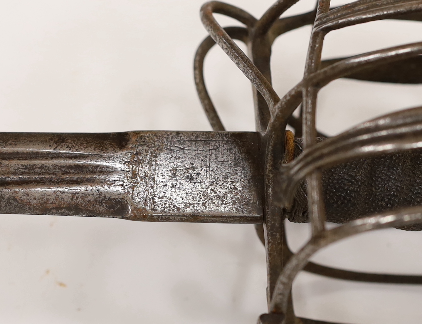 An early 18th century Scottish or English broadsword, with steel basket and pommel and triple fullered Andrea Ferara blade, blade 84cm